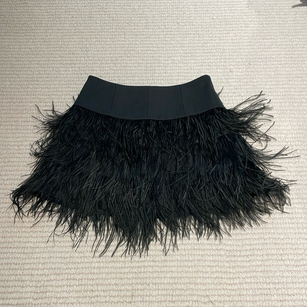 Black feather miniskirt w/ elasticized waistband, fits US 4-6.